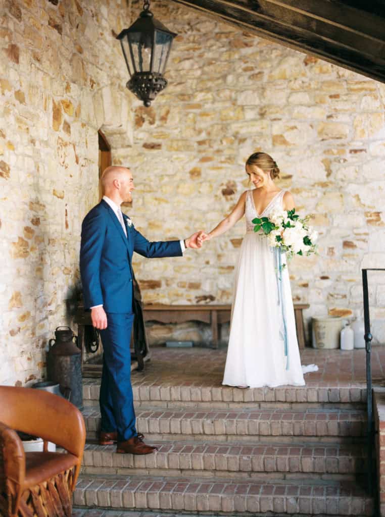 Bride and groom holding hands just moments after their first look
