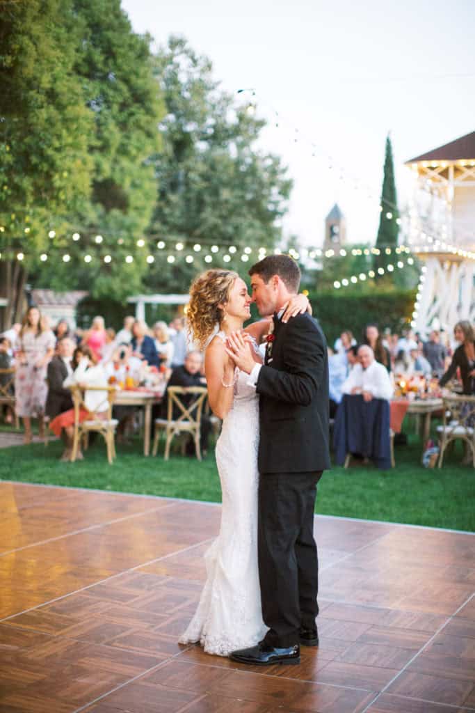 Whitney and Shane share in their first dance during their wedding reception just after sunset