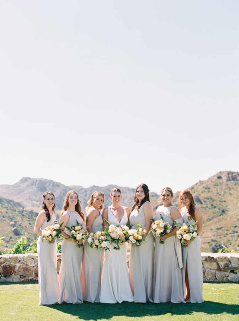 Timeless wedding photo of the bride with her bridesmaids, capturing a moment of love and laughter before the ceremony. Elegant bridal party portrait in soft natural light.