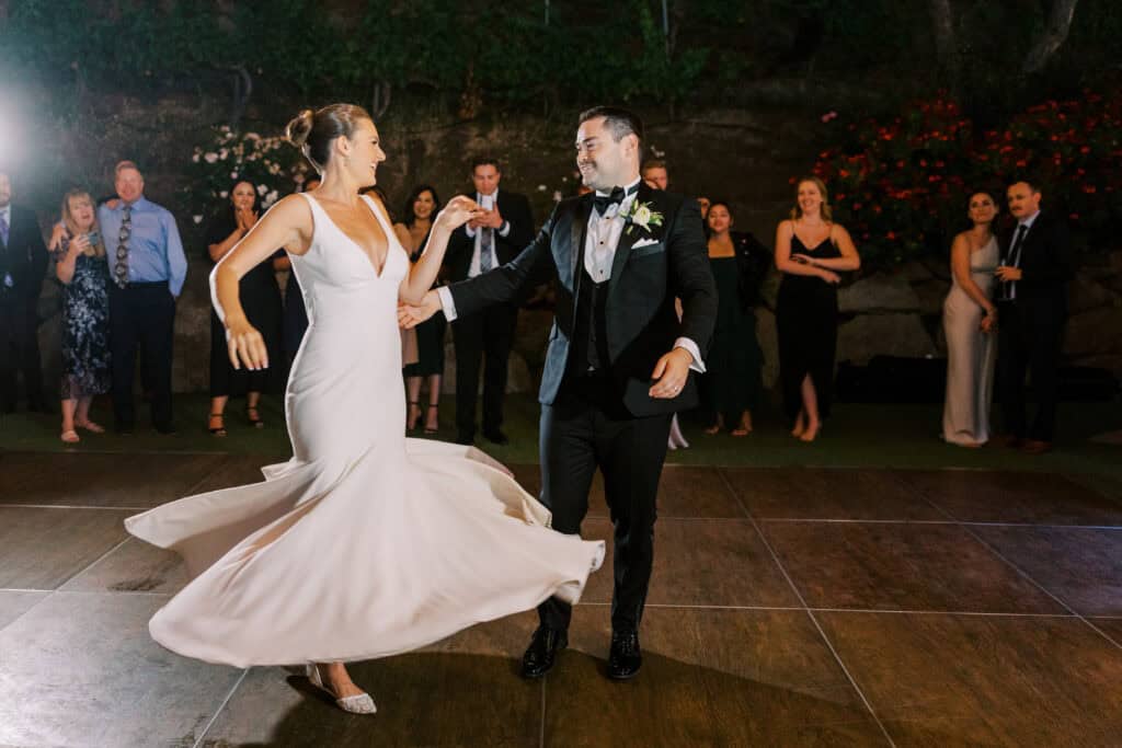 The groom twirls his bride during their first dance at Cielo Farms, capturing a romantic and joyful moment as they celebrate their wedding day.