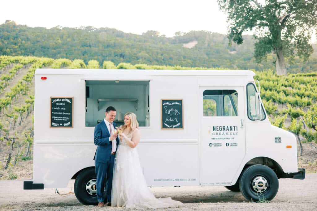 The bride and groom receive their ice cream cones fresh from the Negranti Creamery truck during their wedding reception.