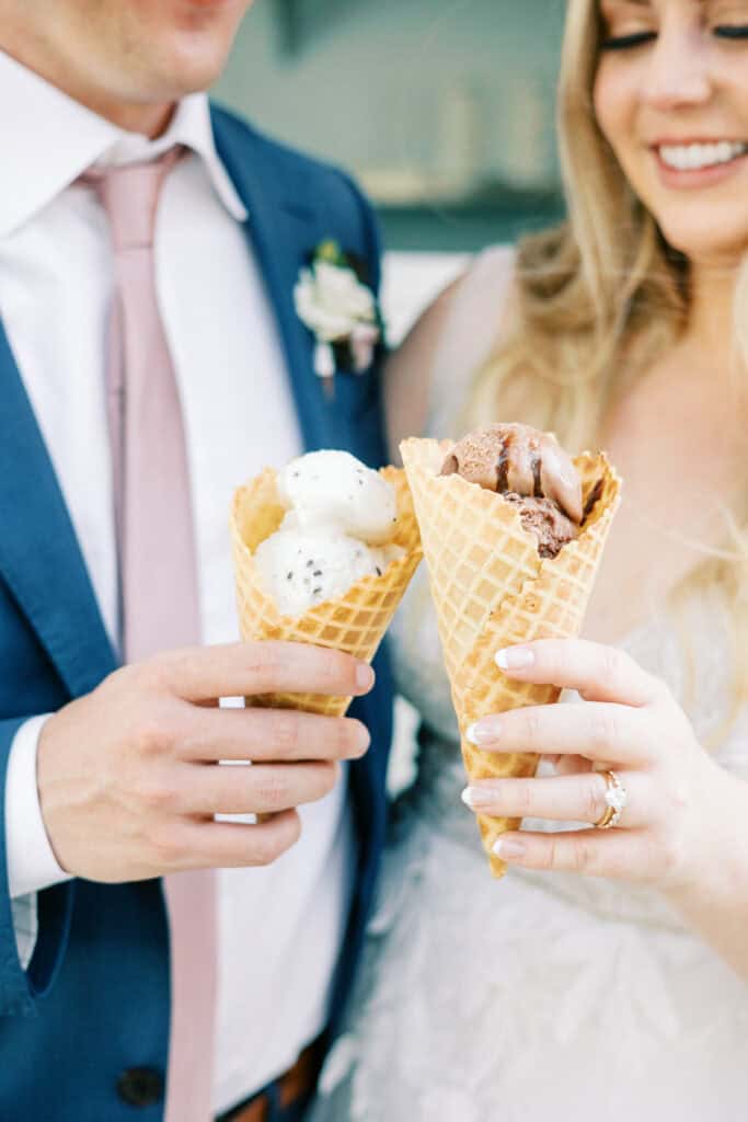 The bride and groom hold up their favorite Negranti ice cream cones with big smiles.