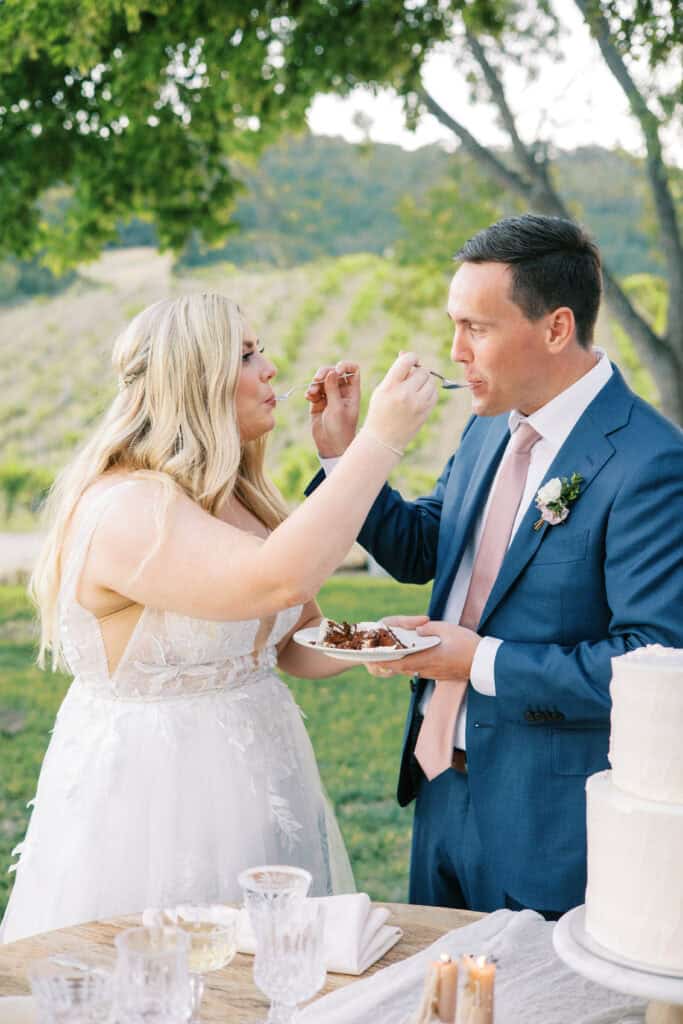 The bride and groom feed each other a bite of their wedding cake during their Hammersky Vineyards reception.