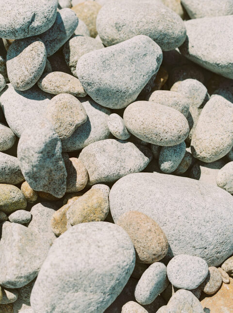 Close-up of the smooth, textured rocks on Pebble Beach, CA.