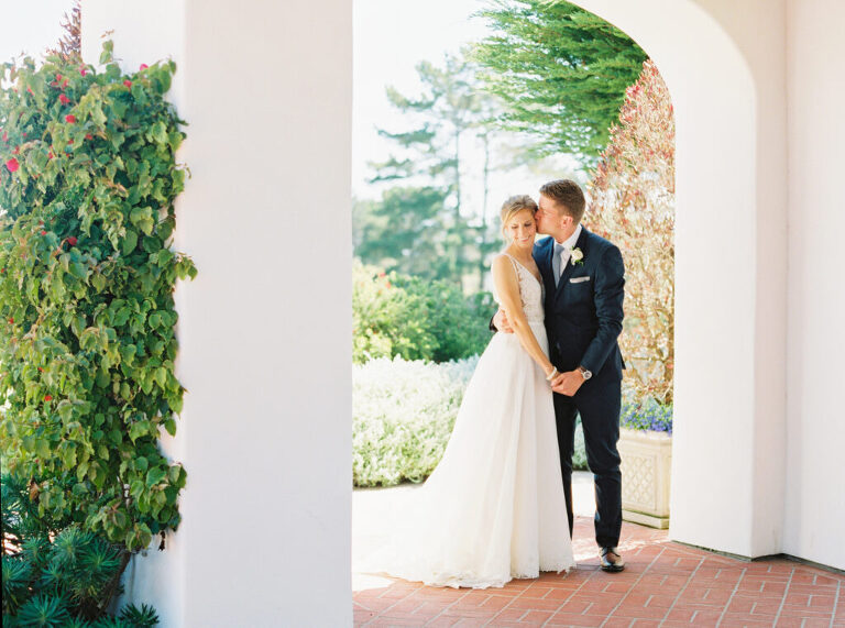 Black and white portrait of the bride and groom embracing during sunset at their Monterey Peninsula Country Club wedding in Pebble Beach, CA.