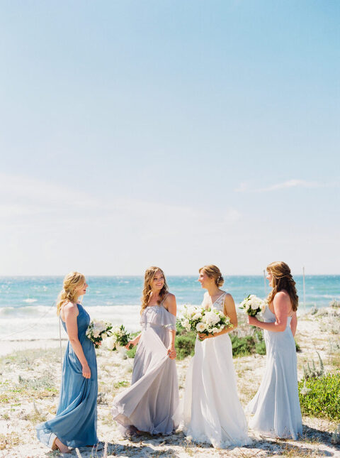 Laura and her bridesmaids twirl joyfully in their dresses on the sands of Pebble Beach, CA.