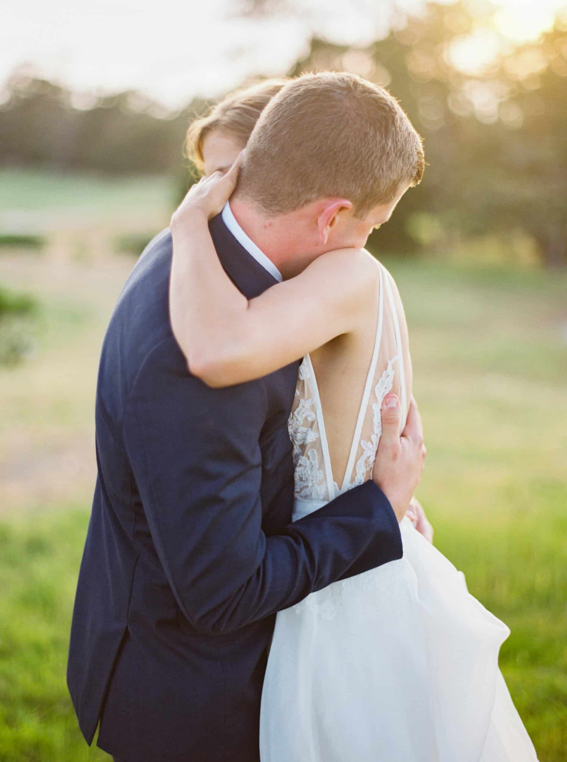 Bride and groom share a sweet embrace during sunset at Monterey Peninsula Country Club in Pebble Beach.