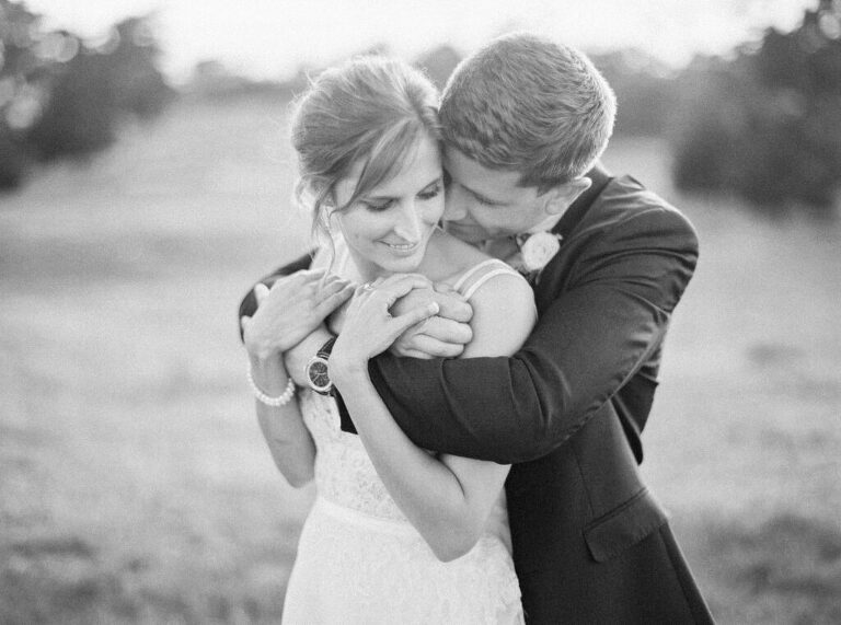 Bride and groom share a quiet moment after their first look, with the groom kissing the bride on the cheek at the Monterey Peninsula Country Club in Pebble Beach.