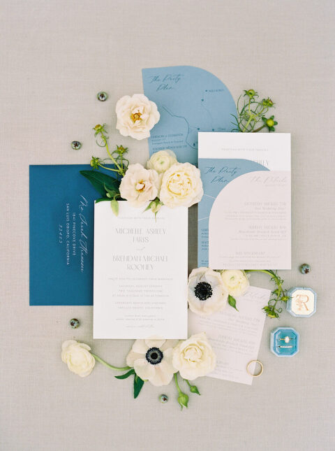 Elegant blue-toned wedding invitation suite designed by Swell Press, styled in a flat lay with classic typography and delicate calligraphy. A timeless and sophisticated detail from Michelle and Brendan’s Greengate Ranch wedding in San Luis Obispo.