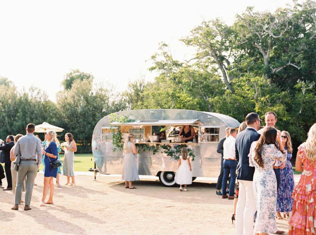 Signature cocktails served from a restored 1951 Boles Aero trailer by Hitched Cocktail Co., adding a fun and nostalgic touch to Michelle and Brendan's wedding cocktail hour at Greengate Ranch.