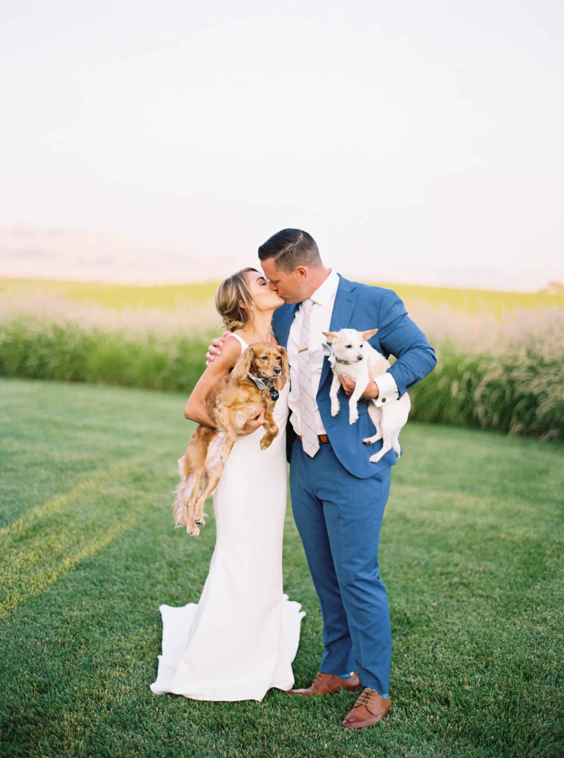 Michelle and Brendan with their two pups in their first official family photo, captured on the lawn of the vineyard cottage at Greengate Ranch, marking a special moment in their wedding celebration.