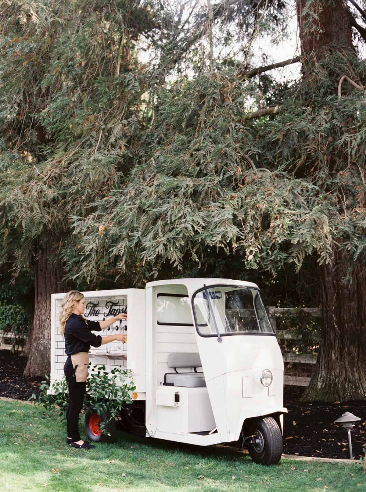 A stylish self-serve beer cart at a wedding reception offering guests a fun and interactive way to enjoy their drinks.