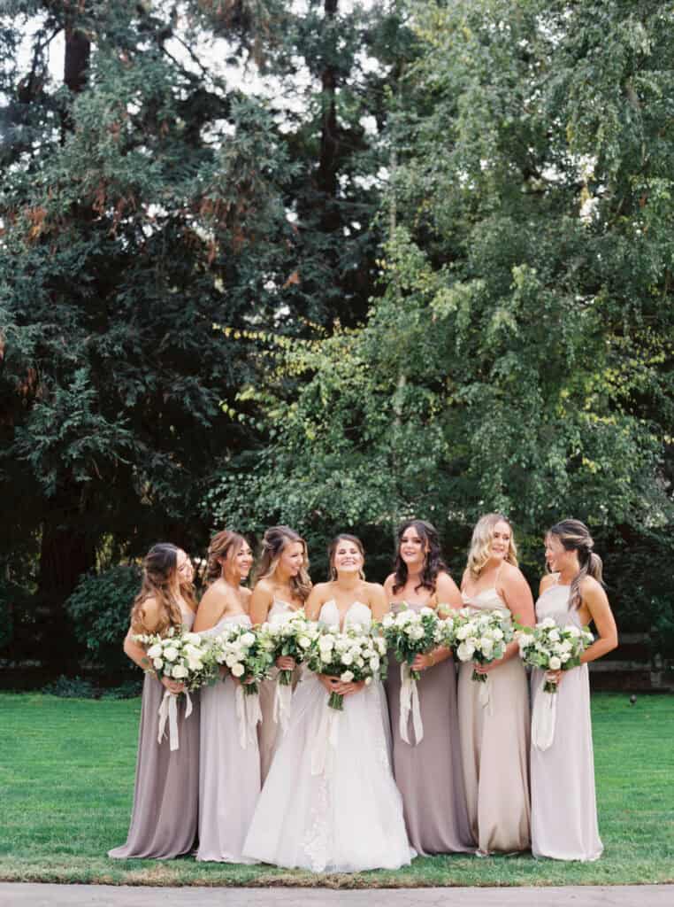 A stunning bridal portrait featuring the bride and her bridesmaids, elegantly posed with their bouquets at a private estate wedding in Lodi, CA.