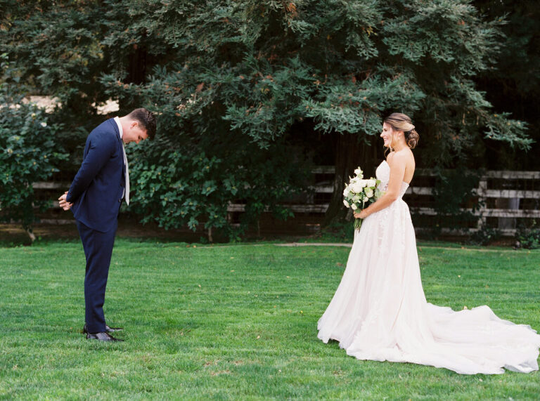 The groom bows his head, overcome with emotion, as he sees his bride for the first time during their first look at a private estate wedding in Lodi, CA.