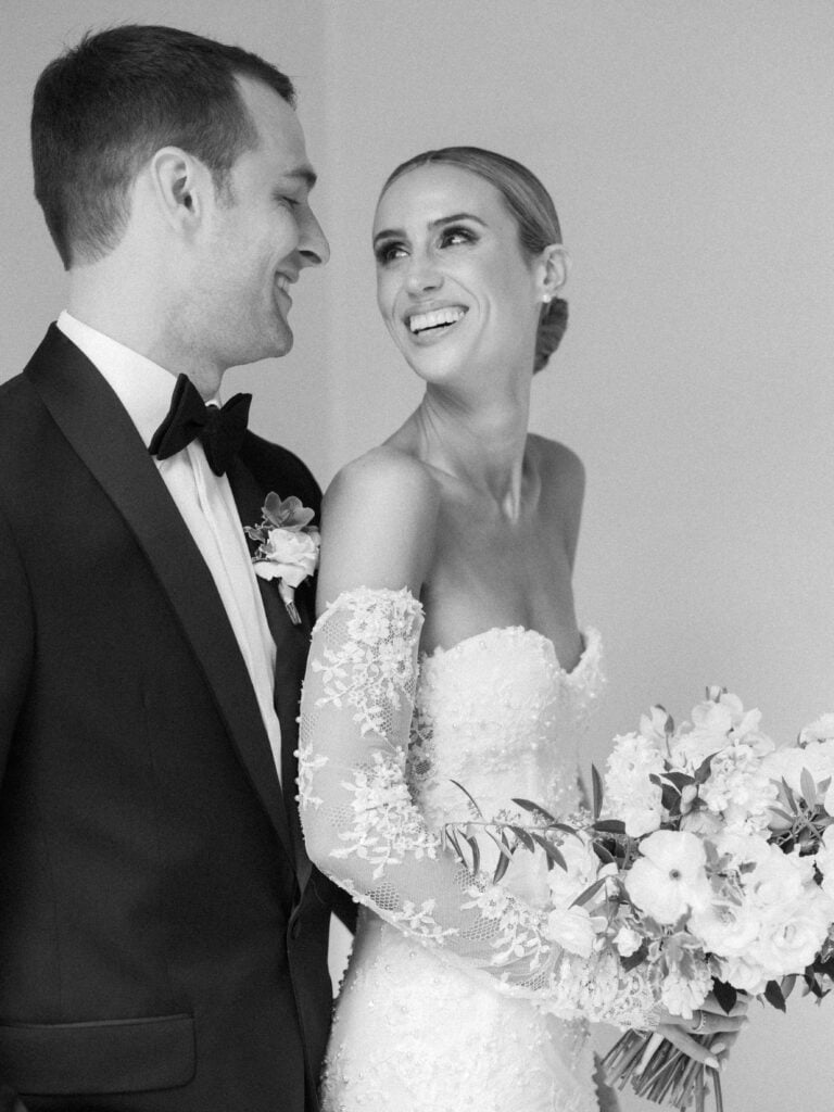 A timeless black and white photo full of joy as the bride looks into the eyes of her future husband before their Santa Barbara wedding. 