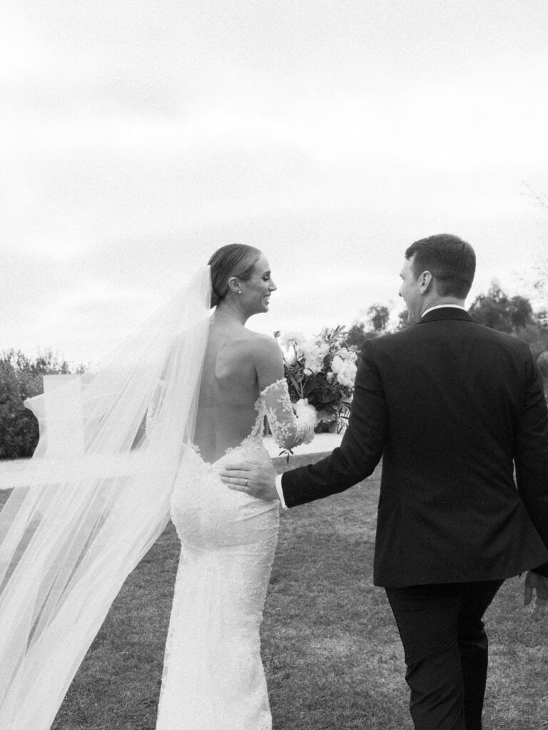 A striking black and white photograph as the newlyweds walk back down the aisle after being pronounced husband and wife at the Ritz Carlton Bacara. 