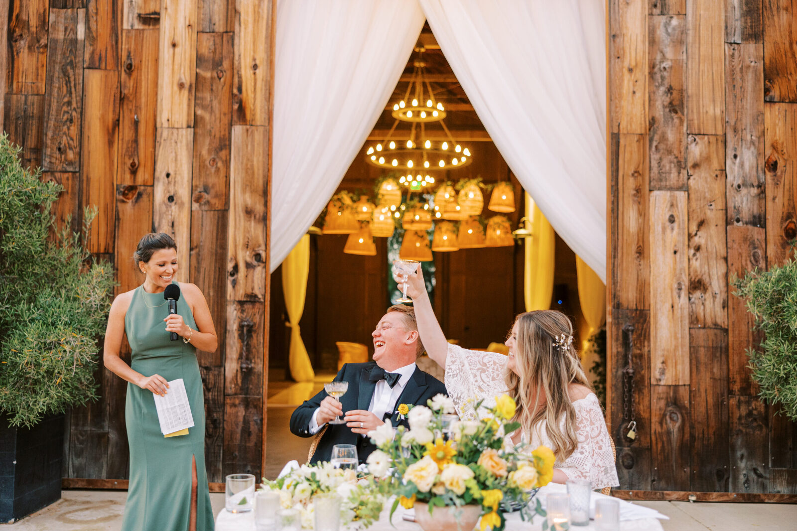 The bride and groom raise their glasses after the maid of honor’s toast at Greengate Ranch in San Luis Obispo.